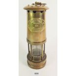 A brass miners lamp for E. Thomas & Williams Ltd of Aberdare. Numbered 61714.