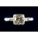 A platinum square set diamond ring (approx 1 ct) on diamond set shoulders, size N/O