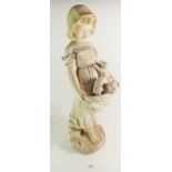 An early 20th century Art Nouveau plaster figure of a young girl carrying a basket of puppies, 52cm