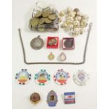A box of tokens, enamel badges and military buttons.