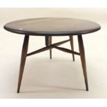 An oak Ercol small circular occasional table with single drop flap and stick supports