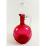 A Victorian cranberry glass decanter with stopper