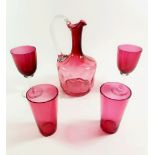 A cranberry glass decanter, a pair of similar tumblers and two glasses