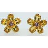 An 18 carat gold pair of earrings of flower form set citrines and sapphires, 11g