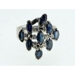 A 14ct gold white gold ring set nine marquise cut sapphires and eight diamonds, size N