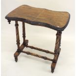 A Victorian walnut stretcher table on turned twin spiral supports