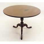 A 19th century circular mahogany tilt top wine table