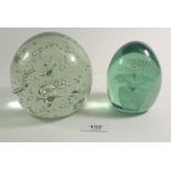 Two Victorian glass dump paperweights, one with internal flower decoration the other a bubble