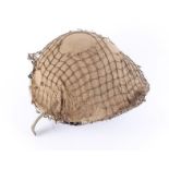1970's British MK4 turtle helmet with khaki string netting and khaki burlap cover