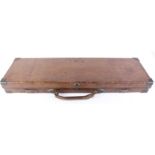 Oak and leather gun case, brass corners, red baize lined fitted interior for 30 ins barrels, with