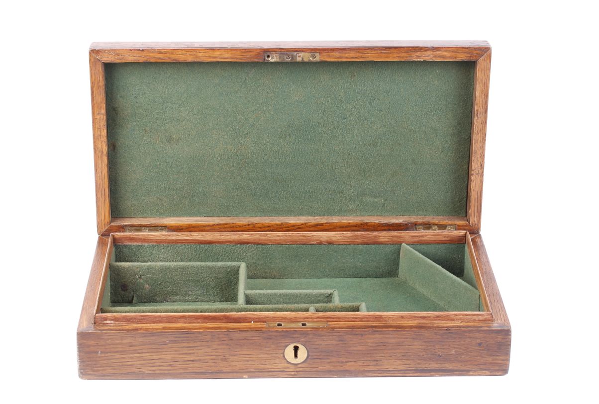 Oak pistol box, brass screw fixings, inset circular brass escutcheon, fitted with green baize