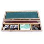 Wooden cased gun cleaning kit incl. three oil bottles, one by Harrison & Hussey