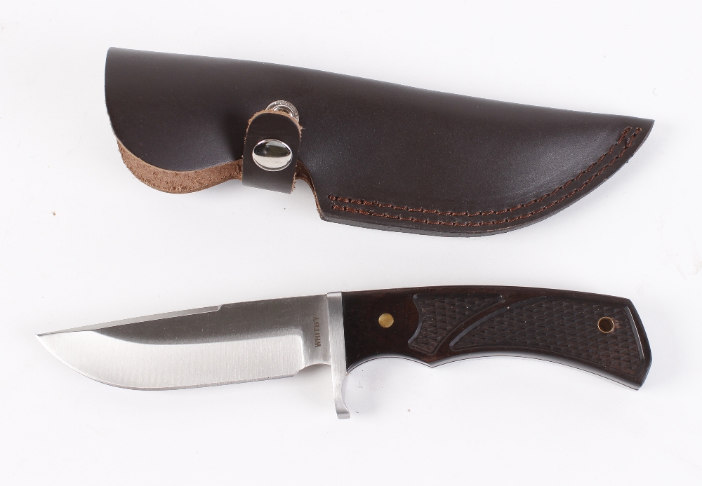 Clip point knife by Whitby, 4½ ins blade, composite grips, in leather sheath [Note: Under the