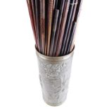 Large quantity of shotgun cleaning rods in brass trench art case