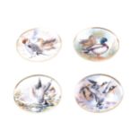 A complete set of four oval porcelain plates, Wild Ducks of Europe, decorated by Raymond Watson,
