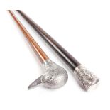 Walking cane with pewter figured duck pommel, and one other cane with decorative white metal pommel
