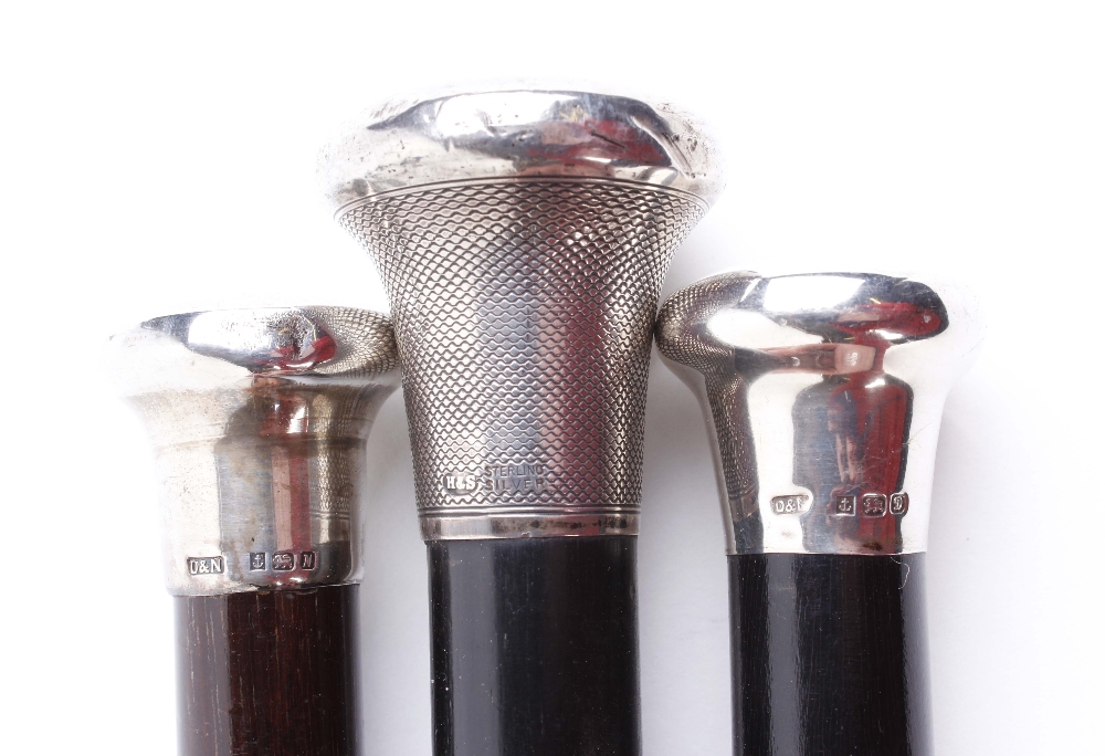 Three tapered ebonised walking canes with silver pommels and metal ferrules - Image 2 of 2