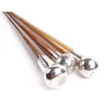 Walking cane with silver pommel together with two similar walking canes