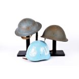 A 1952 British MkIV turtle helmet, having 1970s liner, together with a steel brodie helmet, plus a