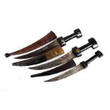 Three 19th Century Egyptian daggers, each having curved blades, with leather and mixed material