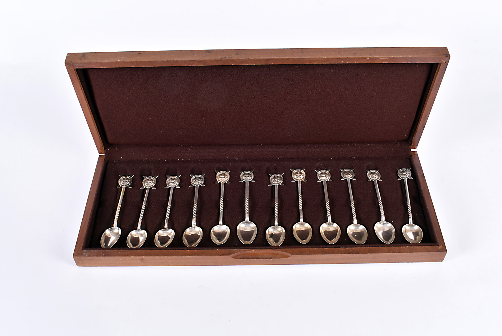 A cased set of 12 Chinese silver spoons, each having Shanghai Scottish emblem terminals, marked to