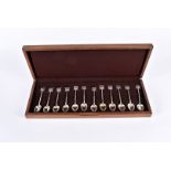A cased set of 12 Chinese silver spoons, each having Shanghai Scottish emblem terminals, marked to