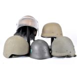 A group of five overseas helmets, to include a Swedish M21/18, with metal decal to front and two