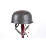 A German M38 Fallschirmjager paratrooper's helmet, marked ET71 and 74 to inner, having remnants of