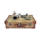 A 1940s period green canvas suitcase, together with two wooden aeroplane models, a musical bust of