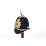 An Officer's blue clothed spike helmet of The Queen's The Royal West Surrey Regiment, brass top