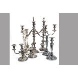 A pair of Victorian Sheffield silver plated candlesticks, together with a pair of later silver