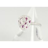 A Victorian style heart shaped ruby and diamond dress ring, the pear cut central diamond in a