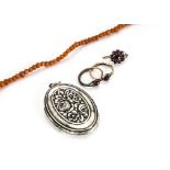 A child's coral bead necklace, 39cm, an Art Deco white metal locket with floral decoration marked to