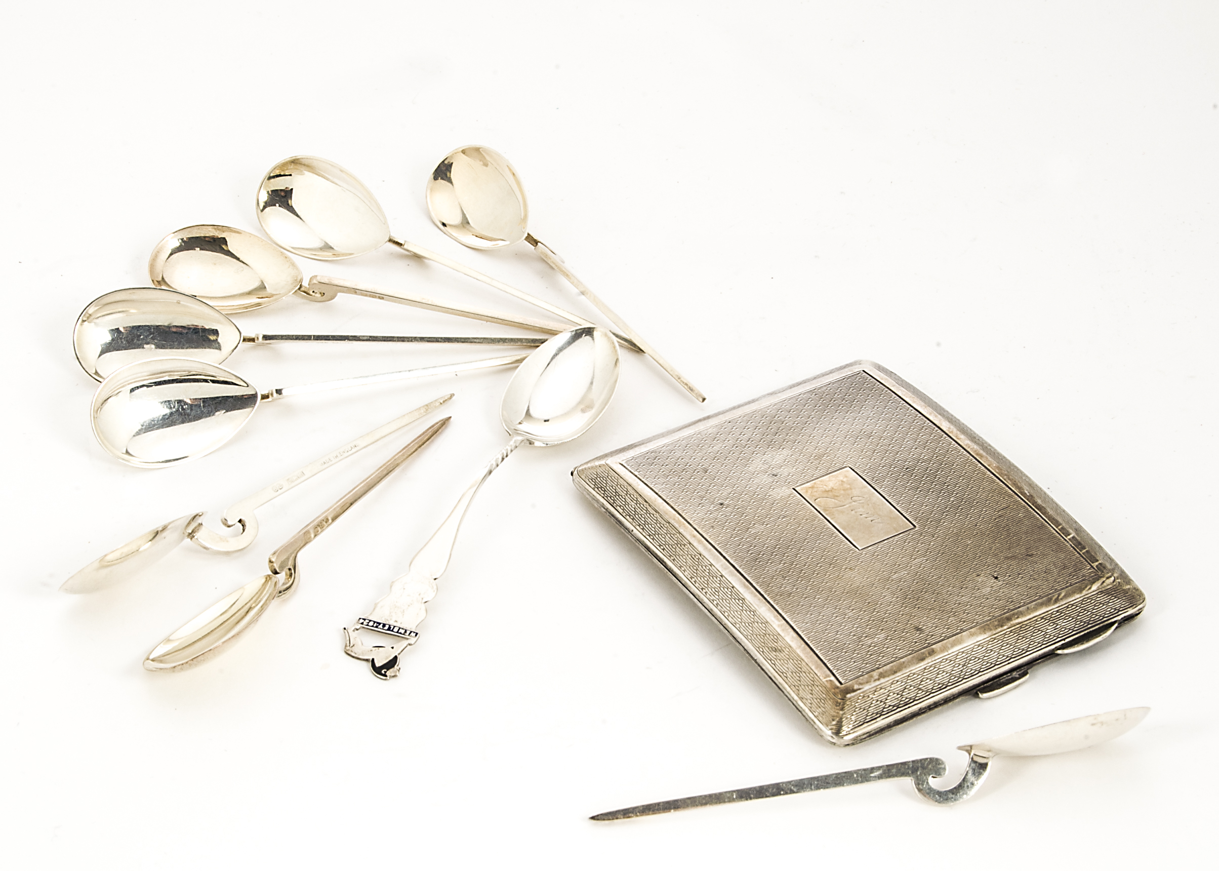 An Art Deco period silver cigarette case, together with a set of eight silver replica Corinthian