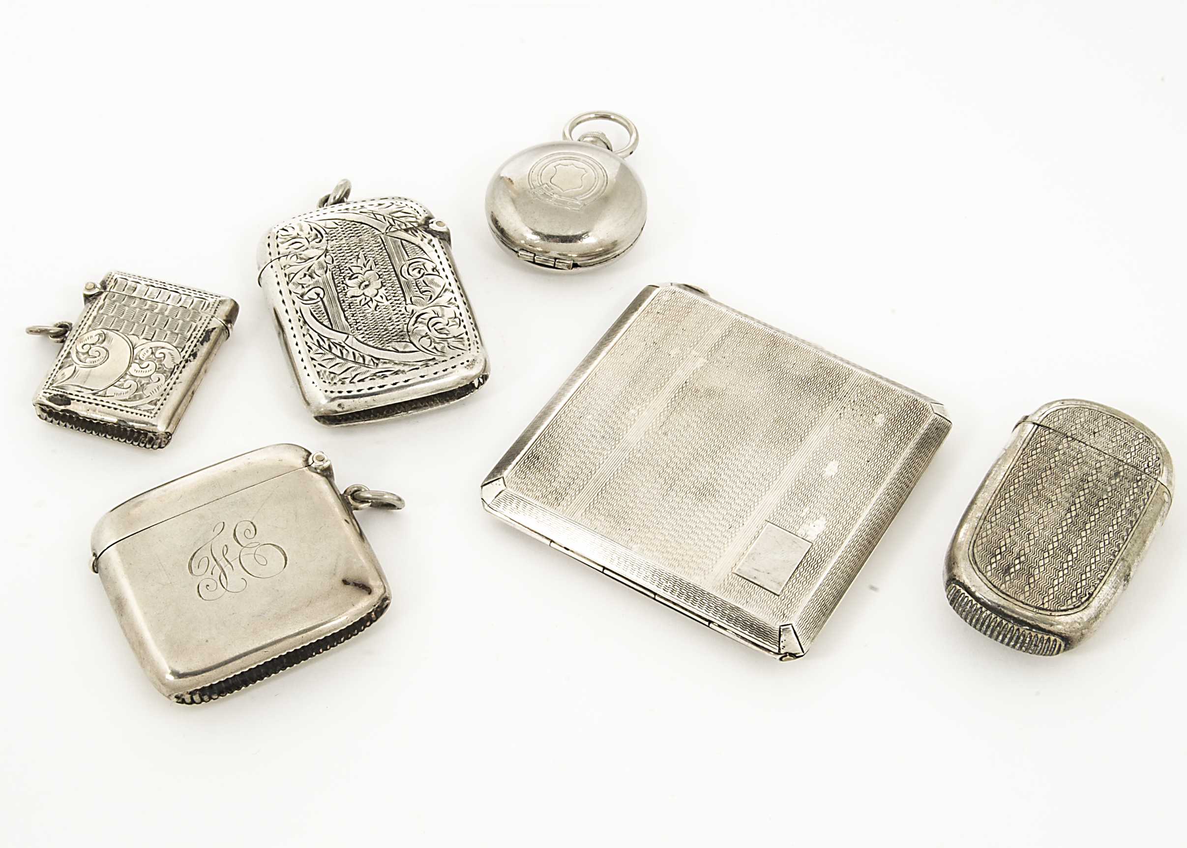 Three silver vesta cases, together with an Art Deco silver compact, and a silver plated vesta case
