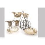 A pair of early George V silver shell shaped butter dishes by HEB & FEB, Chester 1913, together with