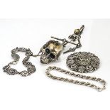 A silver novelty watch chain, with links in the form of bones and skulls with a hand fob and skull
