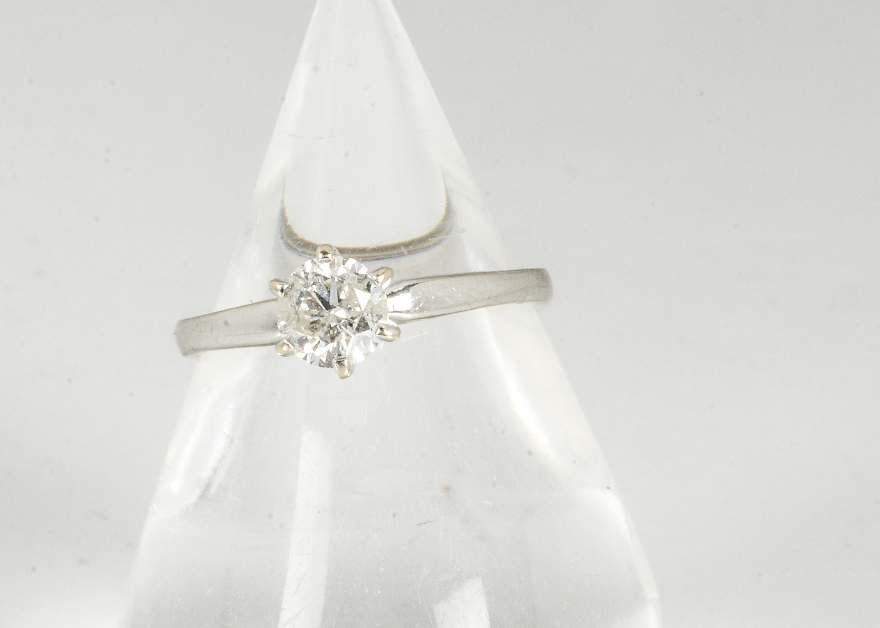 An 18ct white gold diamond solitaire, the brilliant cut in six claw setting on a white gold shank,