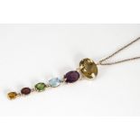A multi gem set drop pendant, in rose gold on a fine oval linked chain, pendant drop 9cm, 14g