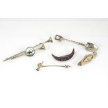 A collection of Edwardian brooches, including crescent seed pearl, horseshoe and hunting horn and