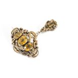 A Victorian ornate citrine oval brooch and pendant drop, the three oval mixed cut citrines in collet