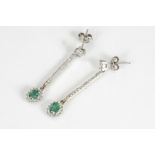 A pair of emerald and diamond drop earrings, the cluster drops supported in a diamond set baton