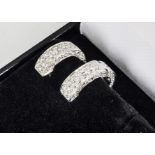 A pair of diamond ear cuffs, the 750 marked pave set ear clips with hinged ends, approximate diamond