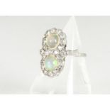 An Edwardian opal and diamond dress ring, the circular white precious opals in a double circle