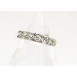 A boxed seven stone diamond half hoop eternity ring, the modern brilliant cuts in channel setting