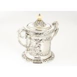 An Edwardian silver biscuit barrel by CW, twin handled with raised floral and rococo motifs,
