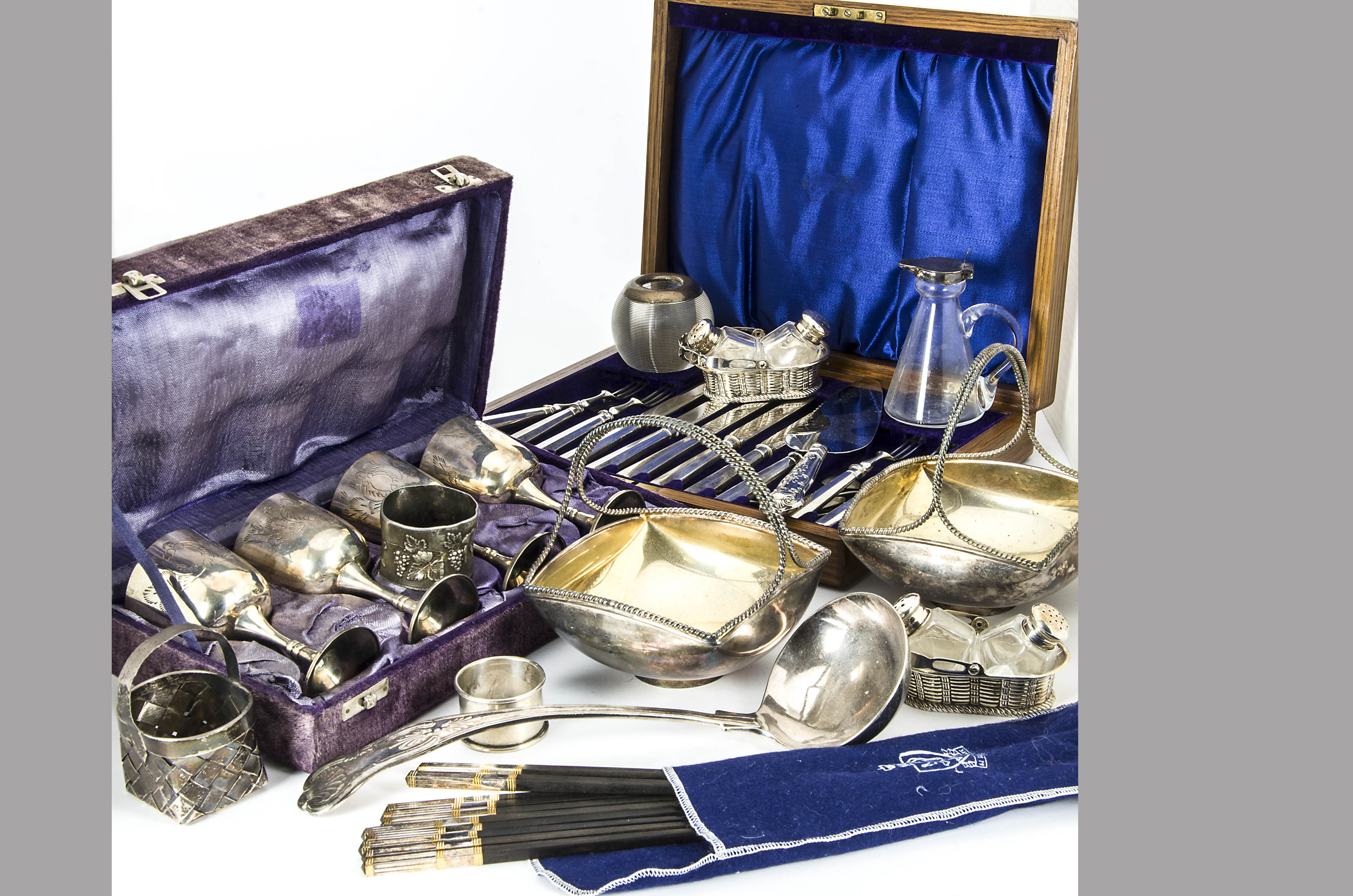 A collection of silver and silver plated items, including a small sterling basket, a glass and