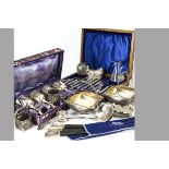 A collection of silver and silver plated items, including a small sterling basket, a glass and