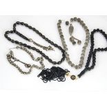 Four worry bead or prayer bead chains, including one resin example with pique work, two in white