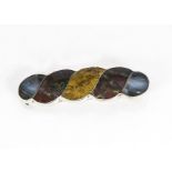 A silver and agate Scottish pin brooch, the scroll brooch mounted with agate, bloodstone and